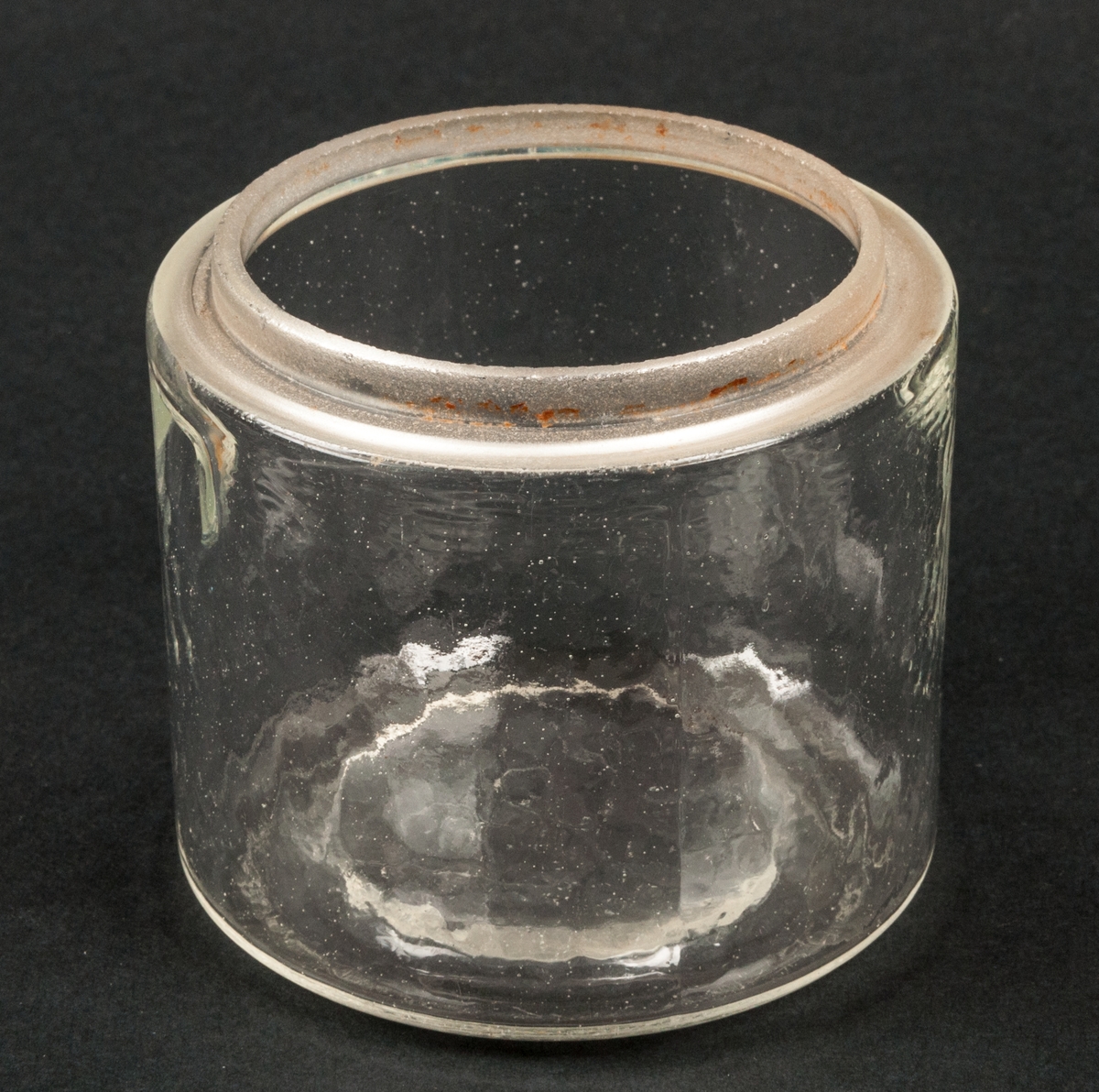 Konserveringsglas, 1/4 liter, med lock.
Glas. Öjämn yta. 2 fördjupningar upptill på sidan. På undersidan märkt i relief "1/4 Ltr".