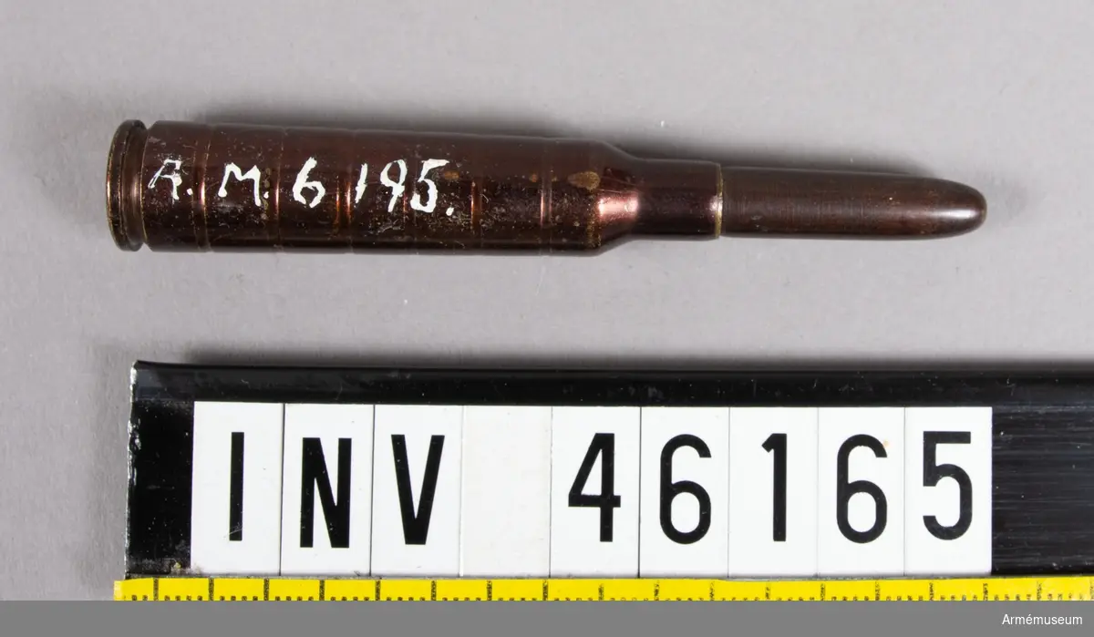 Grupp E V.
6,5 mm hel blind patron m/1906. Till gevär m/1896 och karbin m/1896 och m/1894-1896.