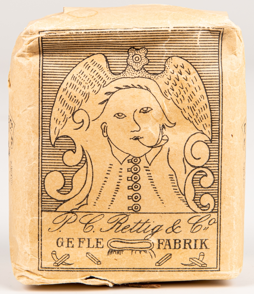 Tobakspaket, av märket "Proberare", från Rettigs fabrik i Gefle.
Bild av stiliserad mänsklig figur med liten pipa i munnen.