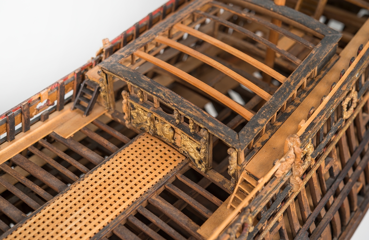 This unplanked model of a three-decker can be dated to c. 1660 and is one of the world's oldest models of a warship. Although not definitively identified, recent research links it to the Swedish ship *Riksäpplet*, designed by the English master shipwright Francis Sheldon and launched in 1661.     
The model was possibly made for Sheldon, who came to Sweden in 1659. He was one of a number of English shipwrights employed by the Swedish crown during the period. Previously, most Swedish warships had been built in the Dutch style.

From around 1660, the English Royal Navy’s administrators commissioned models that were accurately detailed and true to scale. These miniatures, which came to be called Navy or Admiralty Board models, had an unplanked lower hull to emphasise the shape of the underwater body. 

The model was restored by rear-admiral Jacob Hägg in the late 1890s. Missing parts have been reconstructed using lighter coloured wood.

3D model produced by Adam de Kaminski and Vasilis Haroupas for SMTM, 2023
