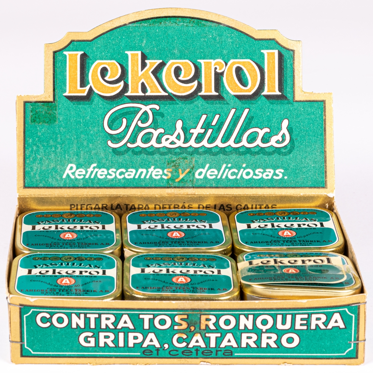 Reklamställ i papp för tablettaskar, innehållande tolv tablettaskar i plåt med texten: "LEKEROL PASTILLAS REFRESCANTES Y DELICIOSAS."
