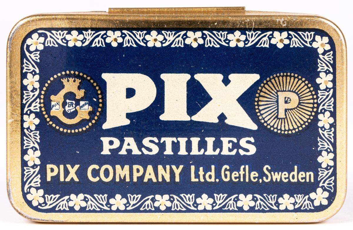 Tablettask i plåt, guldfärgad och blå botten med vit och guldfärgad text:" PIX PASTILLES PIX COMPANY LTD. GEFLE. SWEDEN".