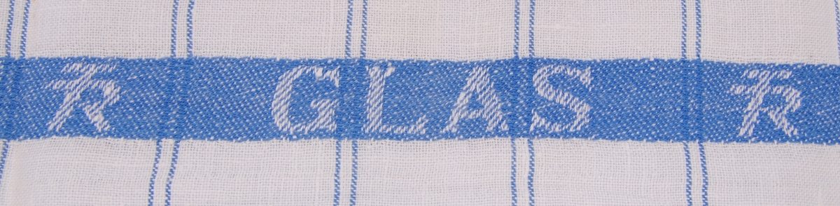 Linnehandduk m vit botten och dubbla blå ränder som bildar ett rutmönster. På långsidorna är det blå bårder med TR-logotyp invävt två gånger och "GLAS" i mitten.