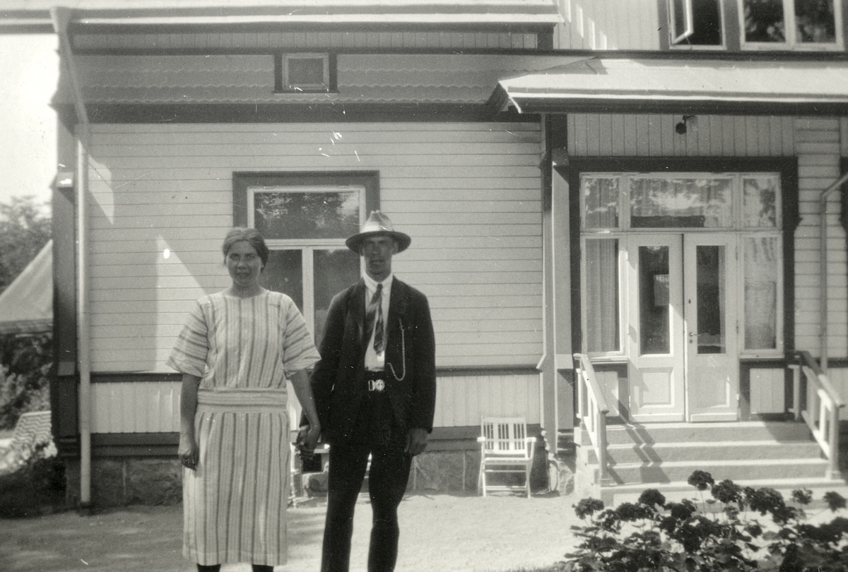 Rut och Fritiof (elev boende på Stretereds skolhem) håller varandra i händerna, ståendes utanför rektorsbostaden i Stretered, 1930-tal. 
Relaterat motiv: A2404.