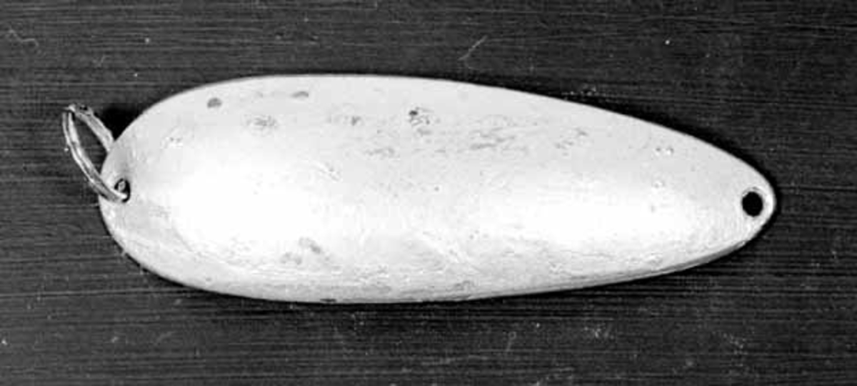 Skjesluk, brukt av Brynjulf Styve i Lågen. 
Sluken er blank, har ett hull i hver ende og en ring i ene enden. 
På ene siden har den en blå og en orange stripe. 