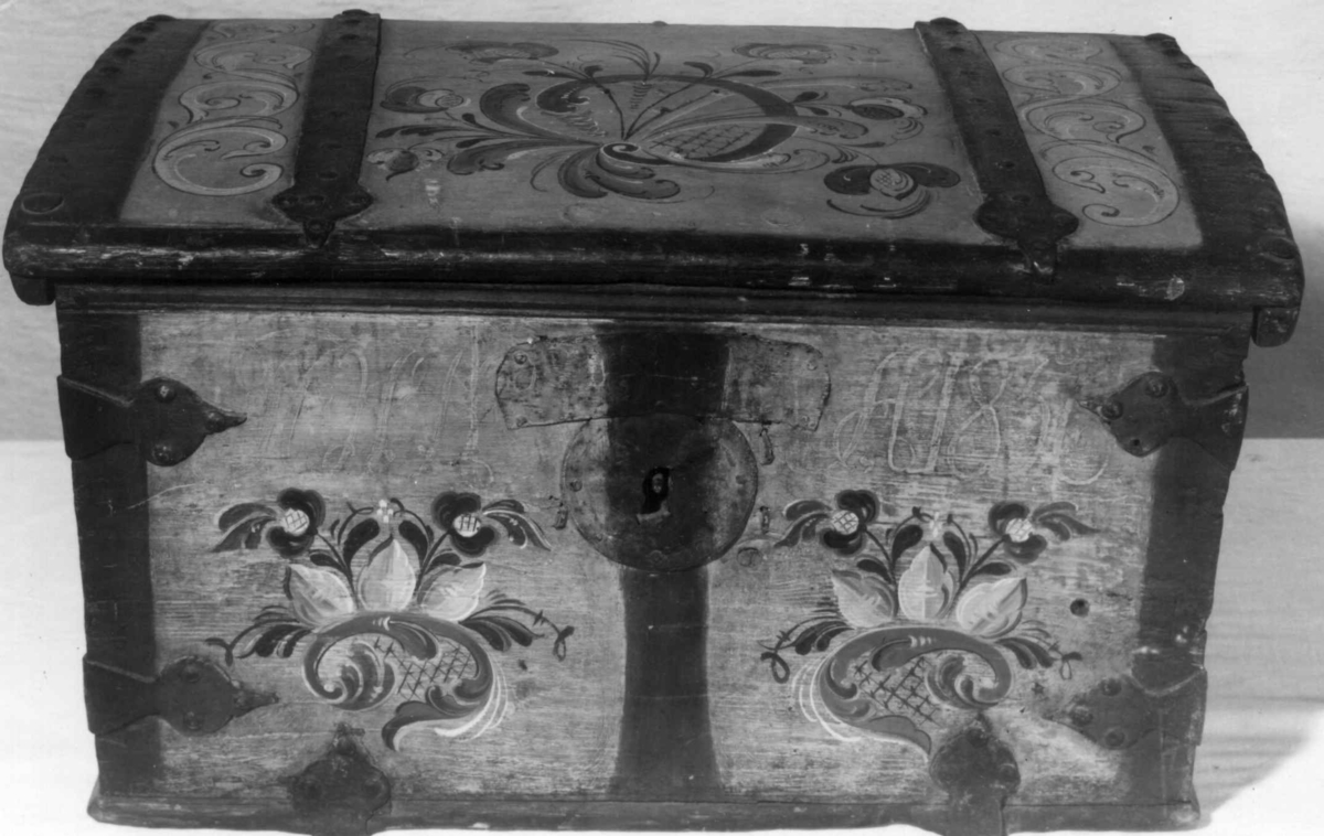Kiste med svakt buet lokk, datert 1856, med senere rosemaling.