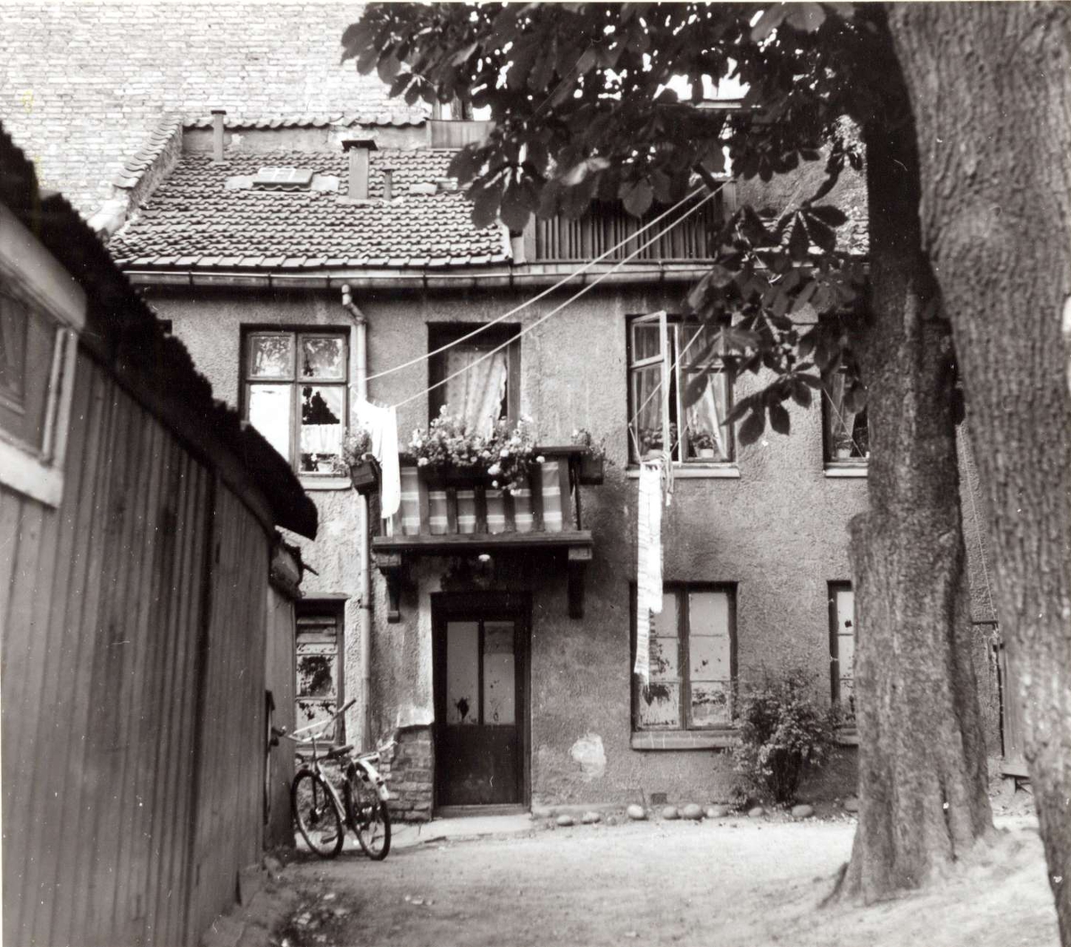 Korsgata 14, Grünerløkka, Oslo 1961. Bakgård med bolighus, uthus og sykler.