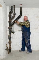 En serie bilder av rørlegger i arbeide i Wessels gate 15.