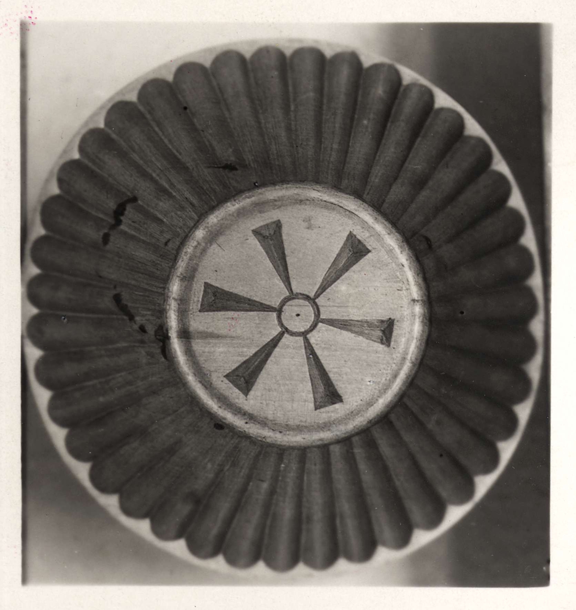 Ett grått 22 x 28 cm stort grått kartongblad med två fastklistrade svartvita fotografier. Fotografierna visar snidade träskålar. Vid ena fotografiet står "B-873" och vid andra fotografiet står "B-874".