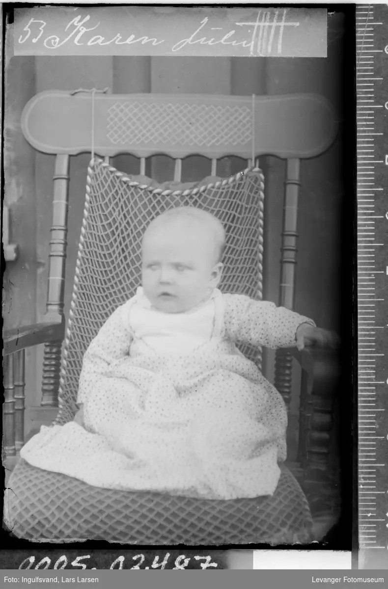 Portrett av et spedbarn i en stol.