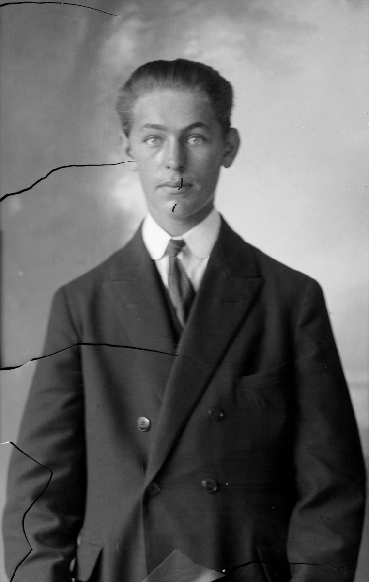 Ateljébild, man  1925 passfoto emulsionsavlossning, repad i ansiktet.