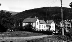 Foto fra en landevei/grusvei, som leder opp til to flotte by