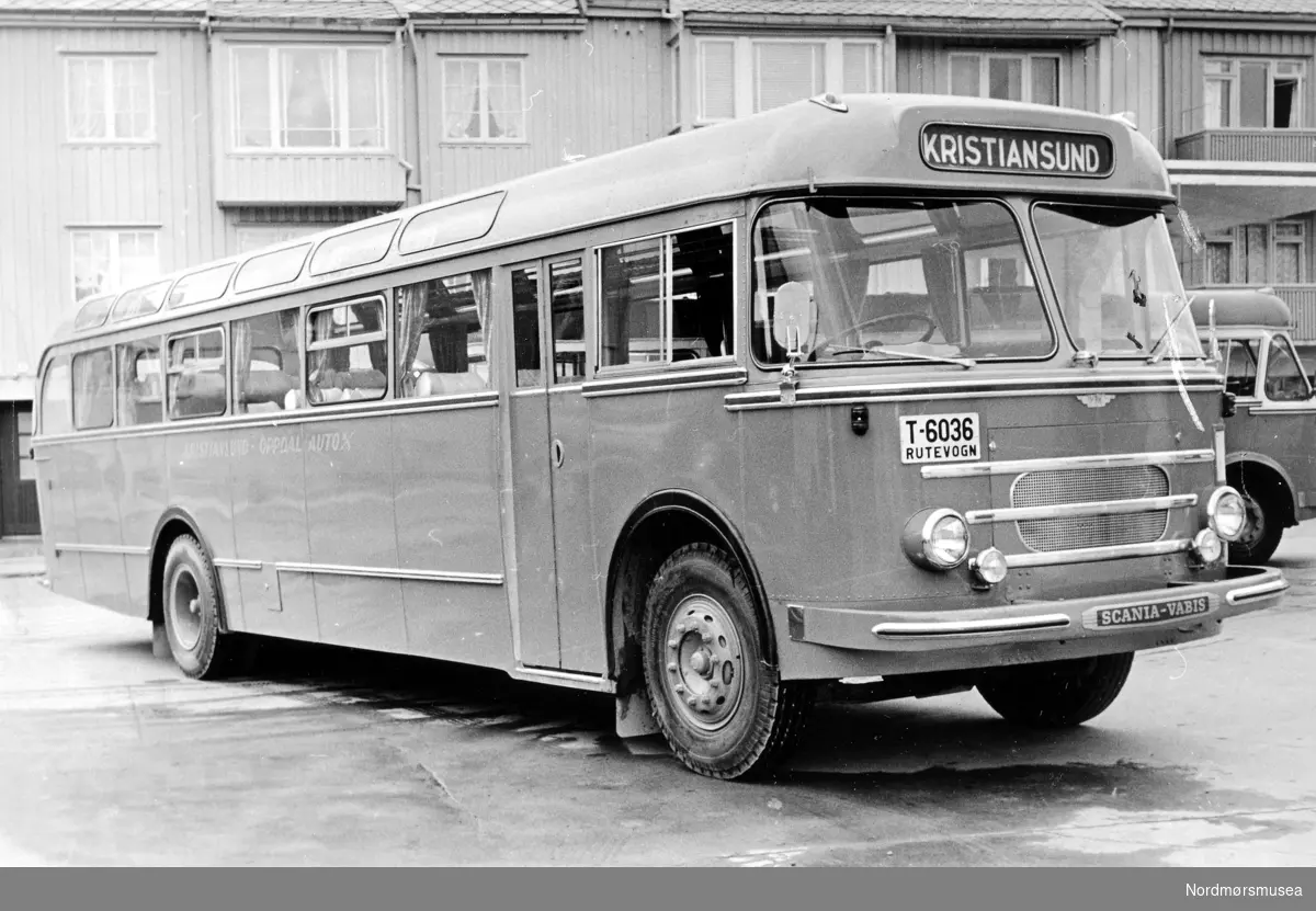 T-6036 var en Scania-Vabis personbuss, 1958-modell, som tilhørte Kristiansund-Oppdal Auto. Som ny gikk den i personrute Kristiansund-Oppdal over Sunndalsøra og Tingvoll. Dette var en svært flott buss med gode stoler og den ble mye brukt som turbuss, også mens den var 10-15 år gammel. Opprinnelig hadde den 34 seter, men den ble en gang tidlig på 1970-tallet ombygd til skolebuss og fikk 45 seter. Bussen var registrert til den var. ca. 25 år gammel. Karosseriet på bussen ble bygd hos Vestfold Bil og Karosseri (VBK) i Horten.
Info: Sveinung Berild - 03.10.2016  Fra Nordmøre museums fotosamlinger.