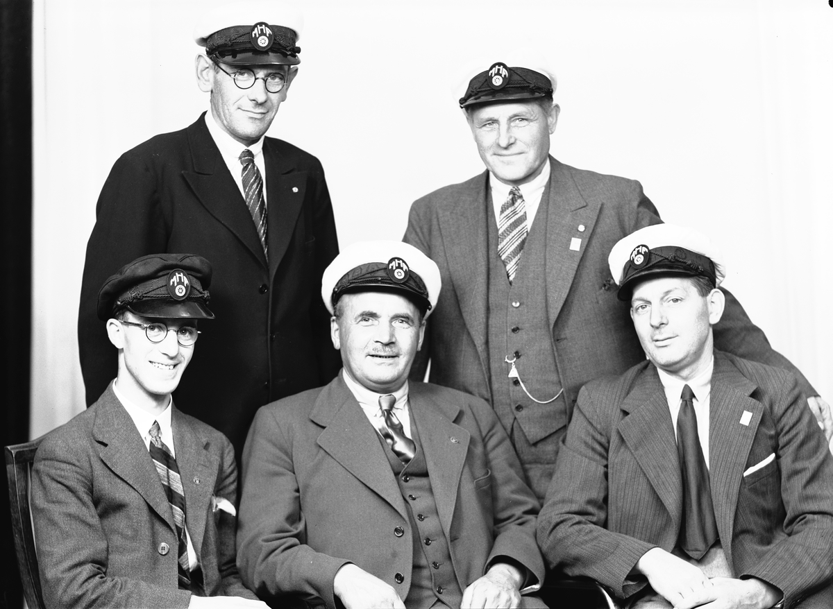 Fem män i M. H. F.-styrelse.