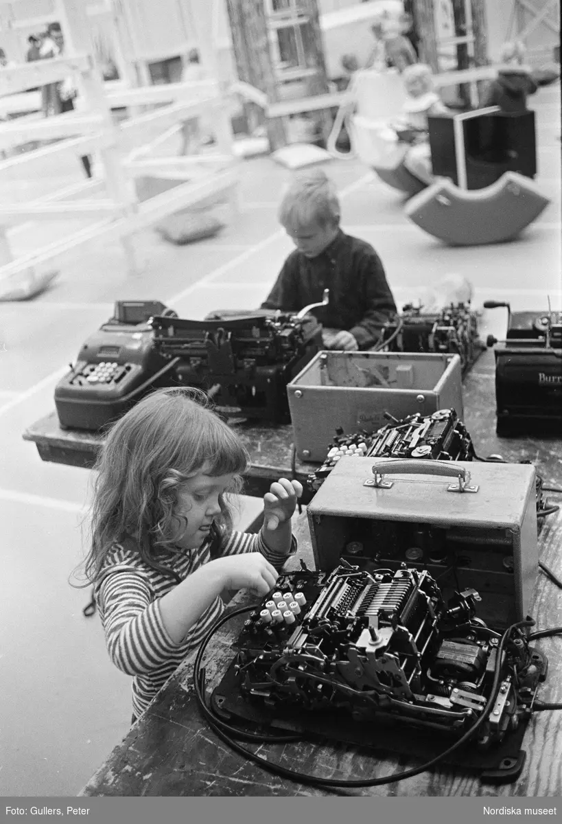 "Modellen", barnverksamhet på Moderna museet, Stockholm. En flicka och en pojke leker med isärtagna kassaapparater.