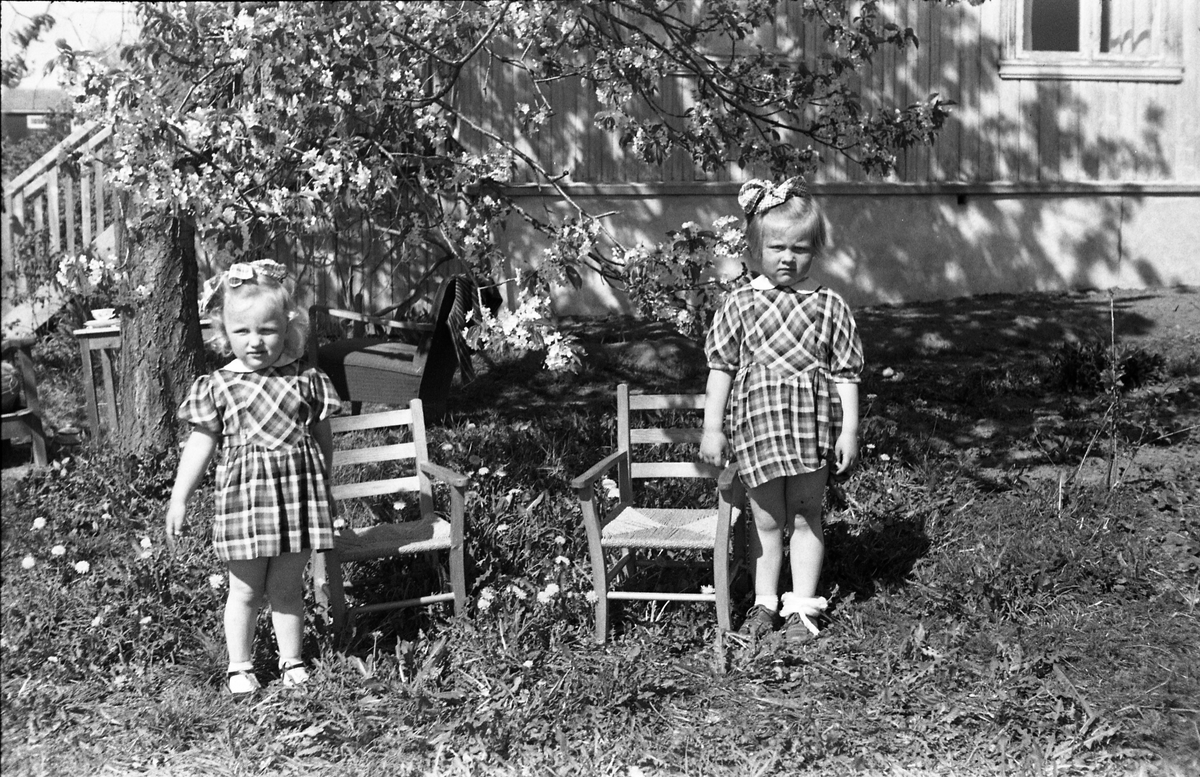 To jentunger i en hage foran et hus. Trolig Anne Lene (eldst) og Turid Sundby. Fire bildere.