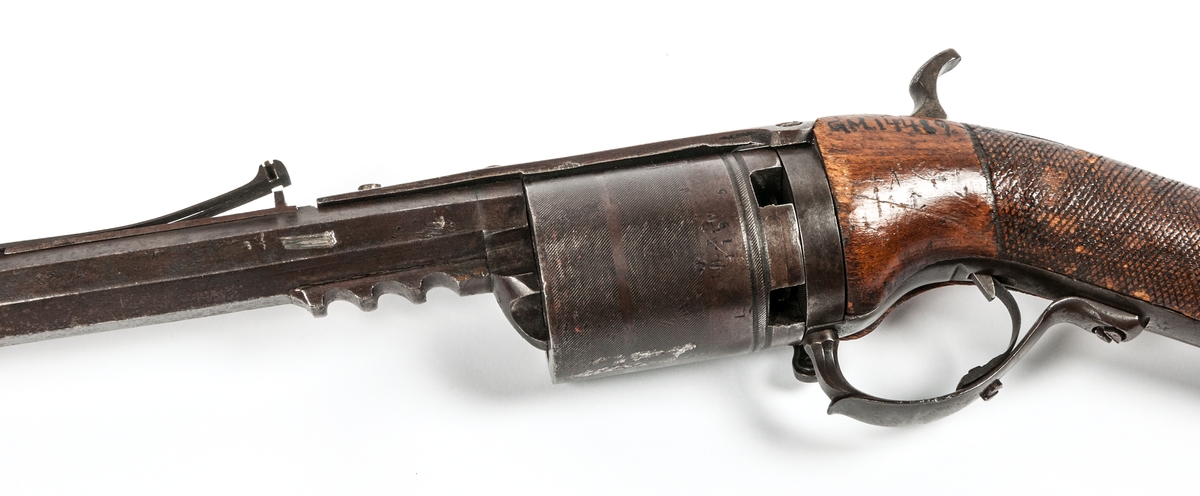 Bössa, revolverpipa med cylindermagasin att vrida runt för hand. Tillverkad av prästen Offrell.