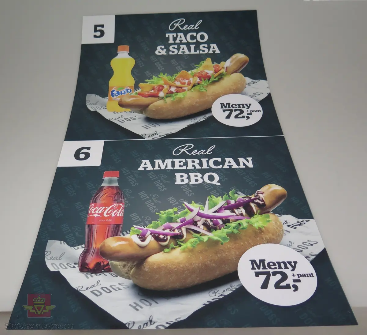 Sju ulike plakater av plast. De reklamerer for salg av pølser og hamburgere hos Statoil.