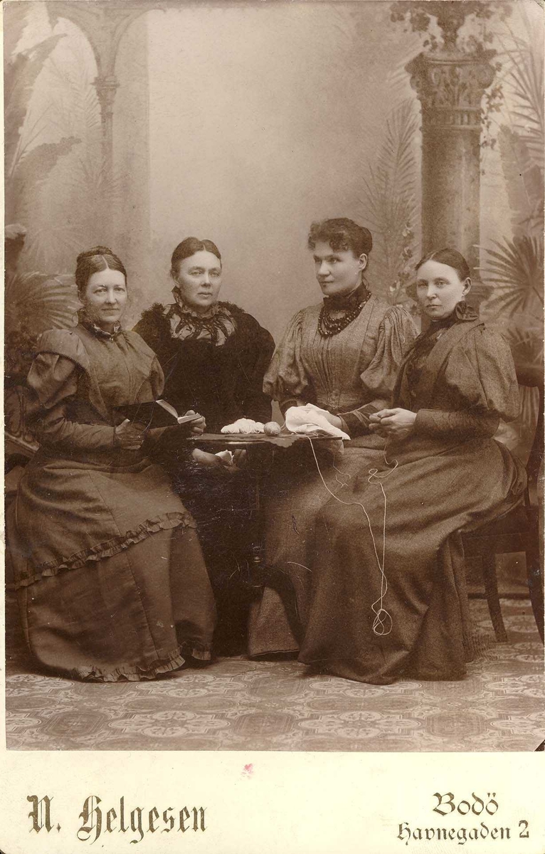 Syforening i Bodø, 4 damer. med handarbeid, ved et lite bord. 
t v fru sokneprest Henrik Eggen. 
En duk sydd av denne foreningen er gitt til museet, NØT 1768 