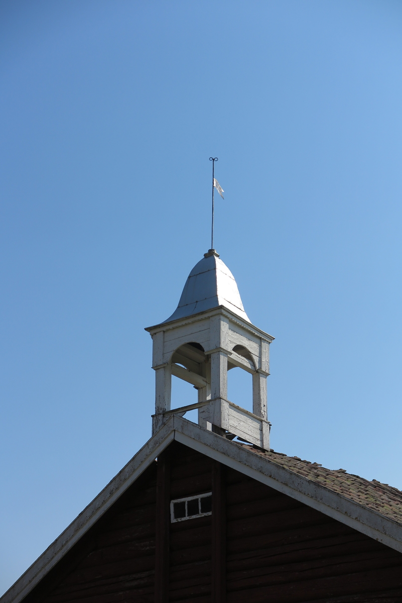Voll nedre. Klokketårn i klassisistisk stil med rester av sveitserdetaljer. Tårnet har buet telttak med blikkplater, og er i middels stand.