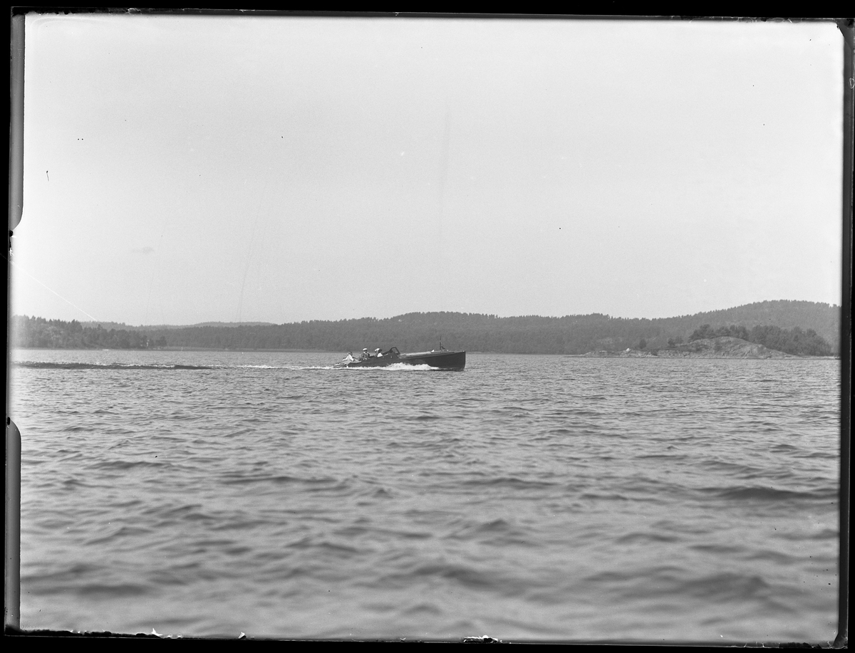 En båt med besättning fotograferad ute på sjön. I fotografens anteckningar står det "Setterbergs racer".