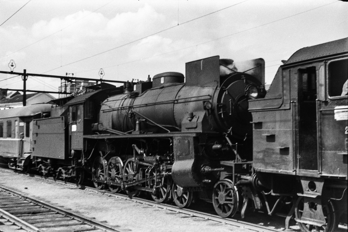 Damplokomotiv type 31b nr. 446 som forspannlokomotiv i persontog på Oslo Østbanestasjon.