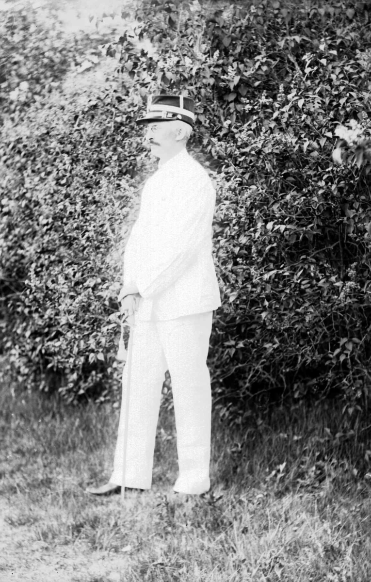 Portrett av mann i en hvit yrkesuniform fra hæren og uniformslue.
