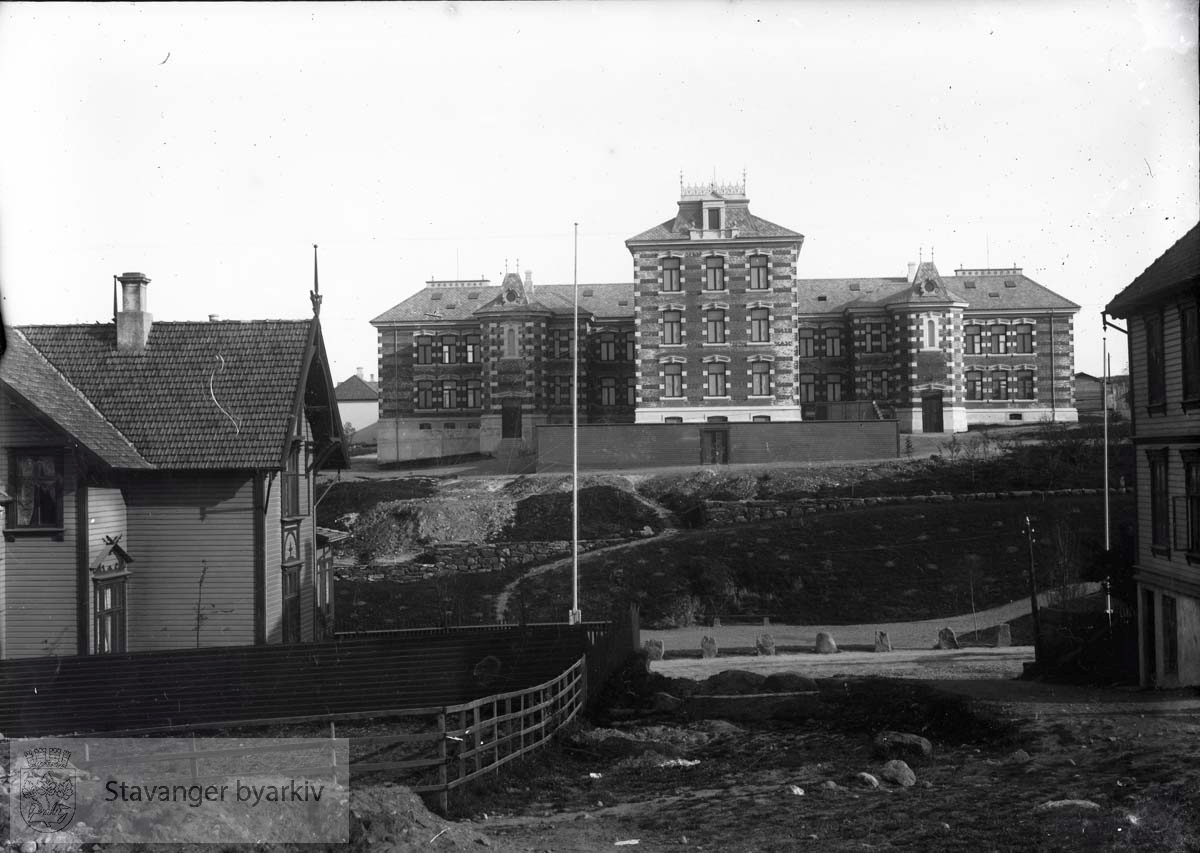 Stavanger sykehus sett fra St. Olavs gate. Stavanger sykehus ble innviet i 1897. Arkitekt Hartvig Sverdrup Eckhoff har tegnet bygget. Sykehuset var anlagt på Eiganesløkke nr.1, det såkalte Skjævelandsstykket..Huset til venstre er Kannikgaten 5 eller 7