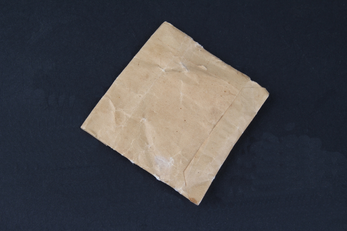 Pulver oppbevart i en brun papirpose.