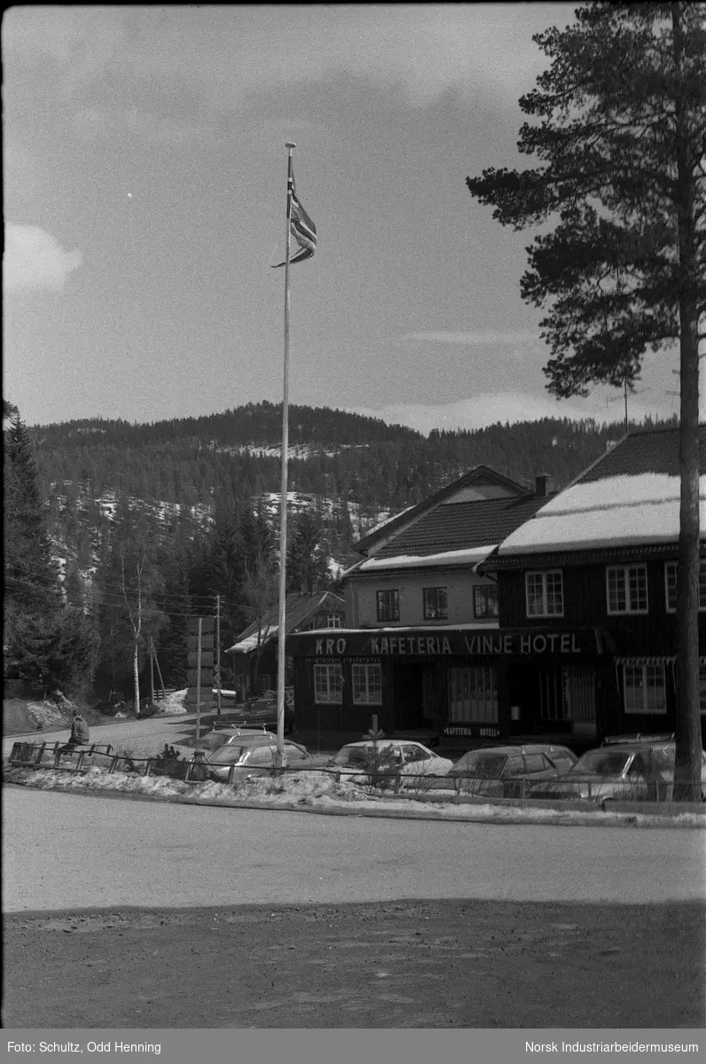 Utendørsbilder av Vinje Hotell, med flaggstang og litt snø.