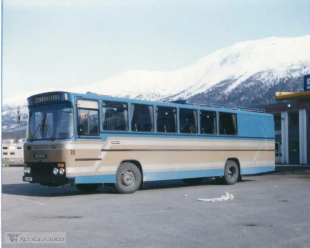 Denne bussen er en Scania F82, 1982-modell, med karosseri fra Vest Karosseri i Stryn. Den hadde 37 sitteplasser og stort godsrom bakerst. Den ble bestilt til Kristiansund-Oppdal Auto (KOA) som i 1982 ble slått sammen med Eira-Eidsvåg Billag (EEB) og navnet ble de første to åra KOA-EEB A/S. Bussen gikk først som skolebuss i Tingvoll og i en lokalrute Tingvoll-Sunndalsøra. Seinere gikk den som skolebuss ulike steder på Indre Nordmøre og Oppdal..(fra Oddbjørn Skjørsæter sine samlinger i Romsdalsarkivet)