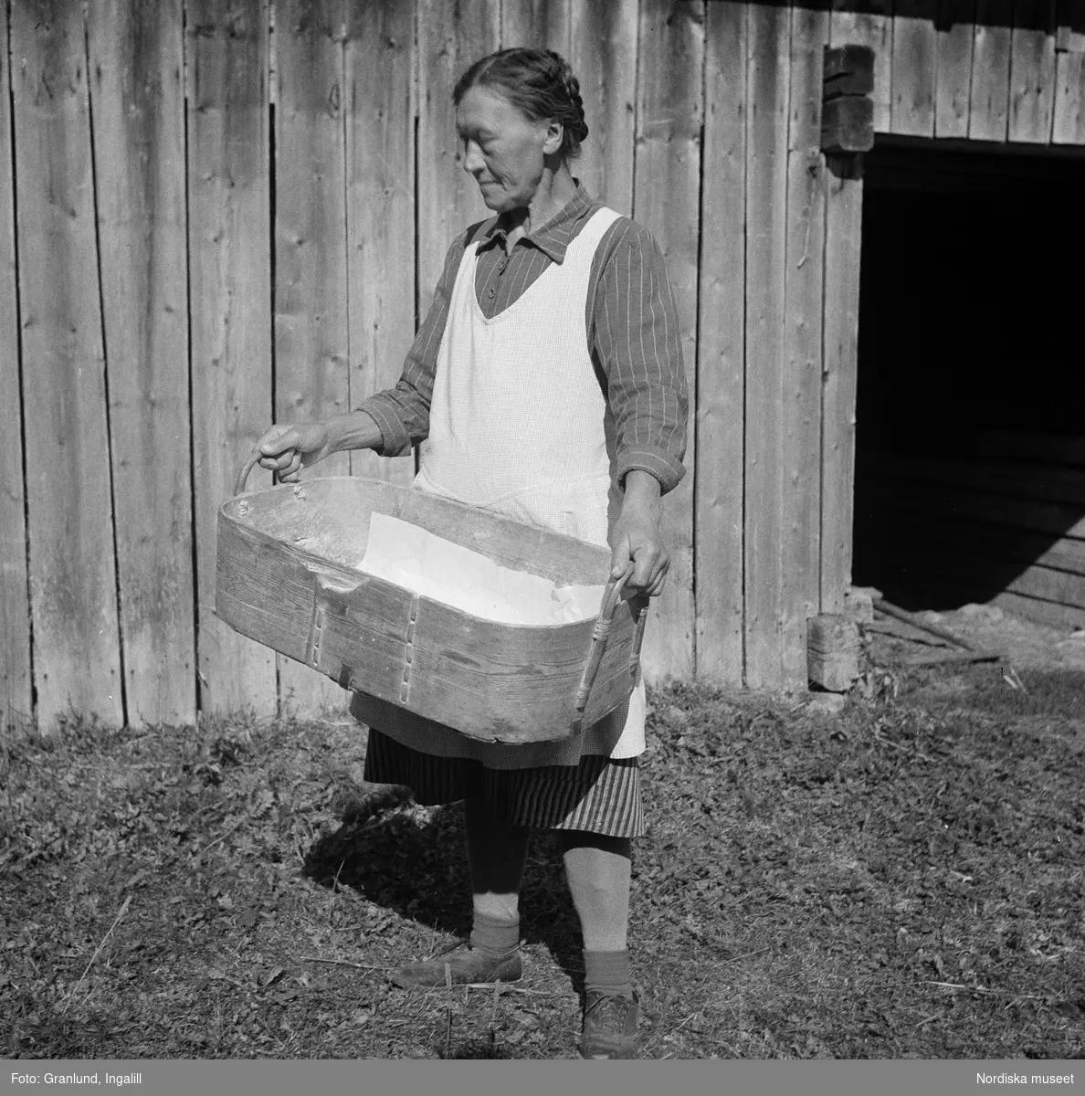 Osmundsbergs by i Boda socken, Dalarna. Röjås Hilda med såskäppa. Användes på vintern att bära in mjöl i.
