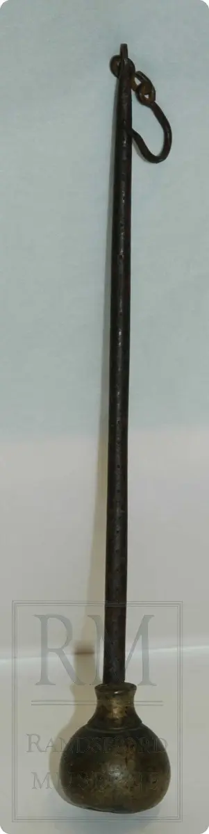 Bismervekt av jern. En avlang sylinderformet stav - med et lodd i den ene enden. Loddet er av messing. Staven har et hull til feste av krok av jern i ene enden.