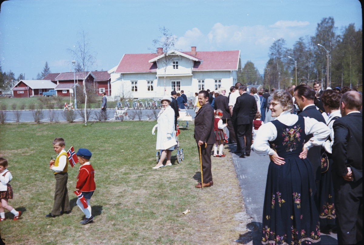 17. mai, Elverum. 1970. Ved ungdomsskolen / Folkvang. Nysted i bakgrunnen. Mennesker på fortauet. 