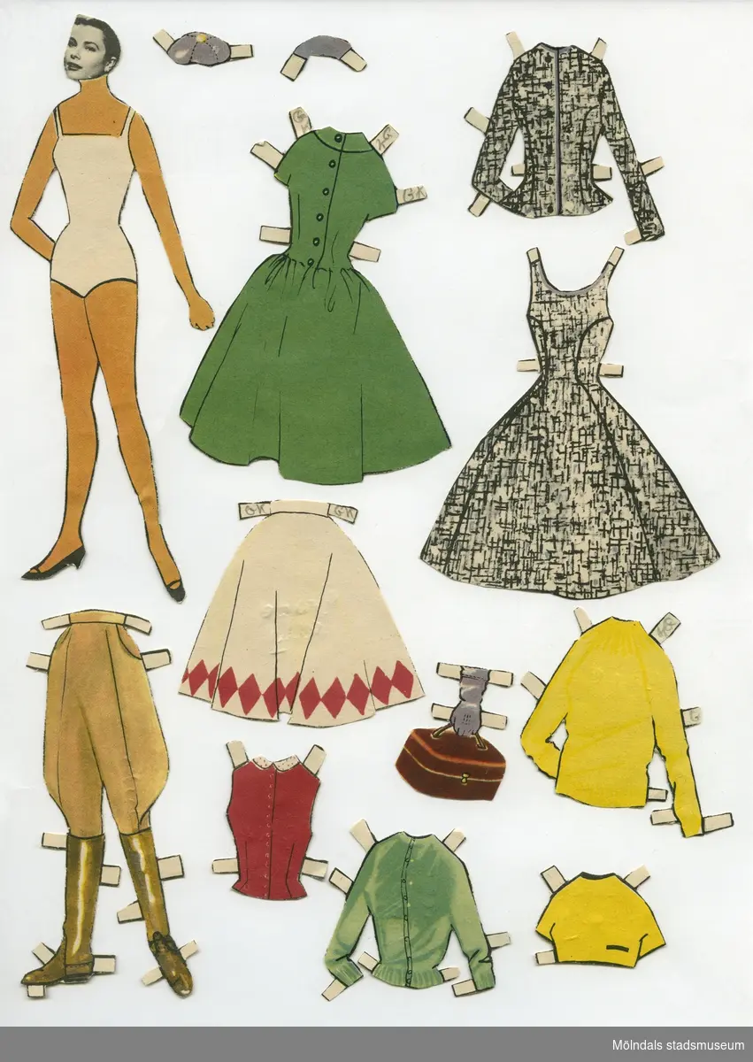 Klippdocka med kläder och tillbehör från 1950-talet. Docka och kläder märkta "Grace Kelly" på baksidan - dockans namn. Dockan föreställer filmstjärnan Grace Kelly (1929-1982), med tecknad kropp, medan huvudet är ett svartvitt foto, urklippt ur tidning. (Huvud och kropp har tryckts på detta sätt, och inte satts ihop i efterhand.) Dockan är iklädd underkläder av baddräktsmodell, samt skor. Garderoben består av två toppar, tre tröjor, en kjol, ridbyxor med stövlar, två klänningar, väska och två hattar. Docka och kläder förvaras i C6-kuvert, med texten "Grace Kelly" fastejpad, av urklippta bokstäver. 